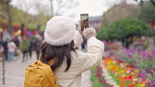 Young female tourist enjoys traveling at Lijiang Ancient Town, The famous tourist destination at Yunnan Province, China