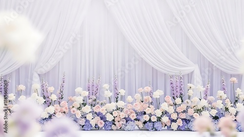An elegant floral backdrop in soft pastels for a dream wedding with sheer white drapes and