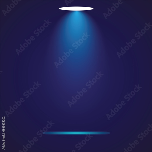 A spotlight shining down in a dark room with a blue glow