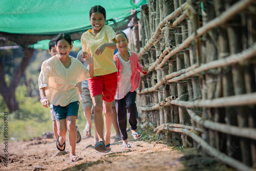 Happy Asian Children Running and Laughing in Rural Village.
