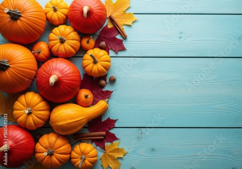Pumpkins and leaves on a blue wooden background for fall season