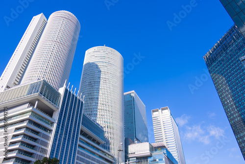 Looking Up at Nagoya Station Skyscrapers under Clear Blue Sky