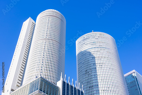 Looking Up at Nagoya Station Skyscrapers under Clear Blue Sky
