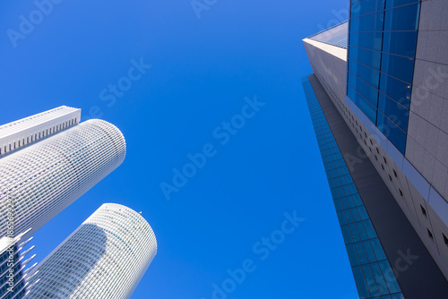 Looking Up at Nagoya Station Skyscrapers under Clear Blue Sky