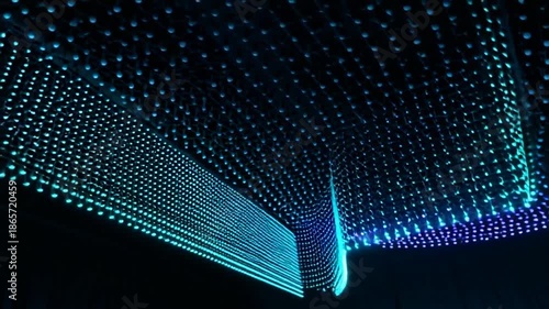Glowing blue dots on black background creating dynamic visual effect