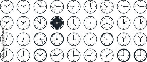 Collection of clocks showing different times with one black clock in the center