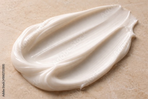 Creamy texture: A macro shot highlights the luxurious swirl of a creamy substance. The elegant display invites the viewer to the realm of self-care.