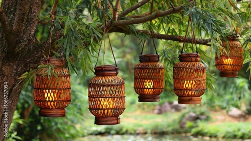 Multiple woven bamboo lanterns illuminate a lush green outdoor setting near water