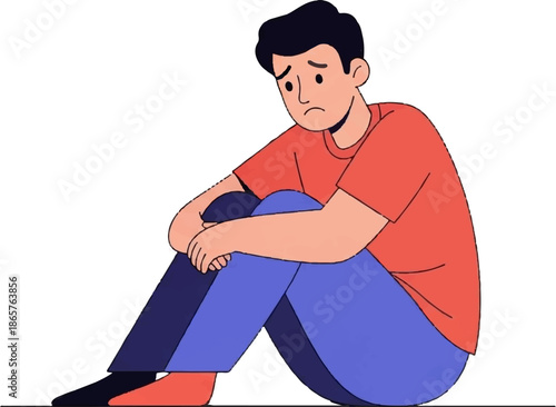 A person sits with knees to chest, head down, appearing sad or contemplative