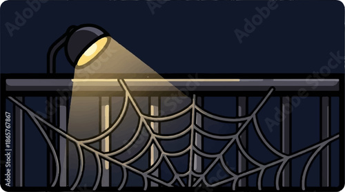 Illuminated spiderweb on a railing against a dark night sky