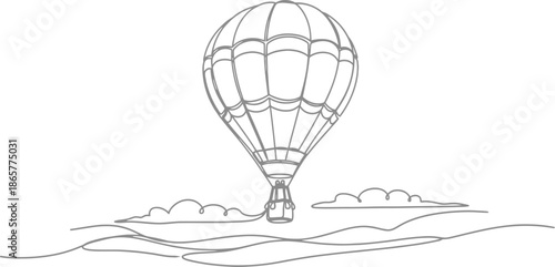 Hot air balloon floating over rolling hills