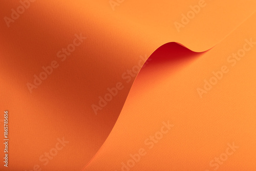 Cuadro en lienzo Flowing abstract paper surface in warm orange tones with a smooth curved fold fo