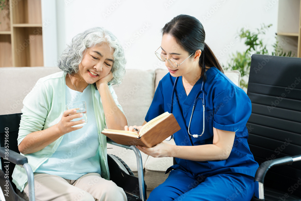 Obraz premium Asian nurse consulting elderly woman in wheelchair at home. Senior care, home healthcare, nursing support, communication and caregiver concept