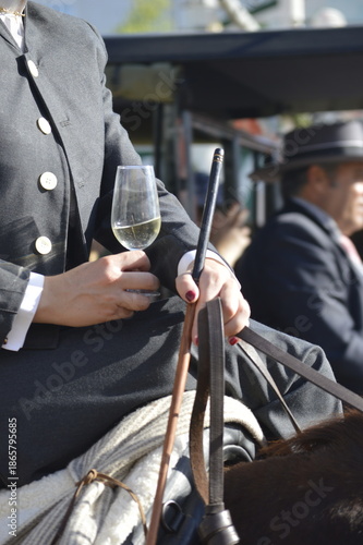 Horse rider with a glass of wine in the world famous Feria de abril from Seville, Andalusia, Spain 
