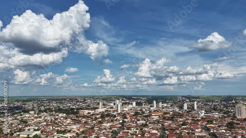 A timelapse video of a bustling city under a vibrant blue sky with white clouds