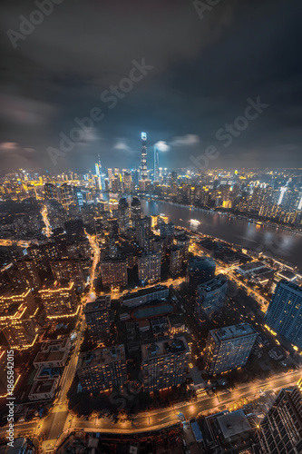 Canvas Print Shanghai Skyline at Night with Huangpu River Under Dramatic Cloudy Sky