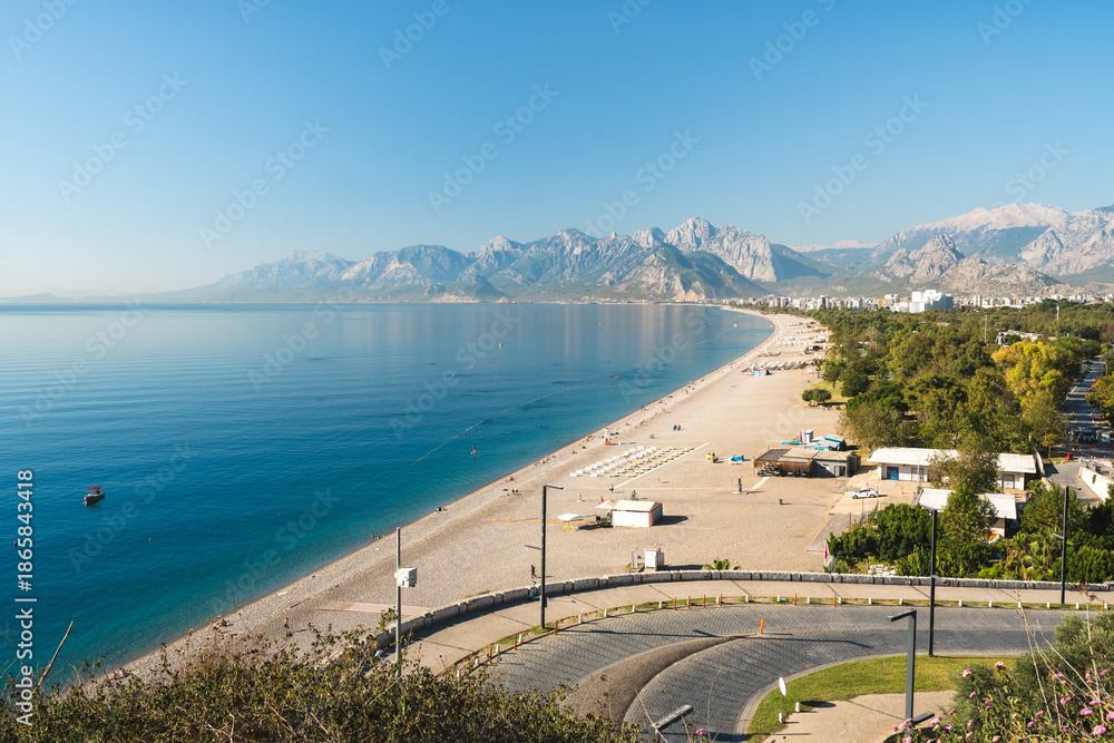 Naklejka premium Aerial view of Konyaalti beach and pine-covered coastline at sunrise in Antalya