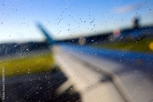 Looking through window of airplane leaving Swiss Zürich Airport with close-up of aircraft wing on a sunny autumn morning. Photo taken November 3rd, 2025, Zurich, Switzerland.