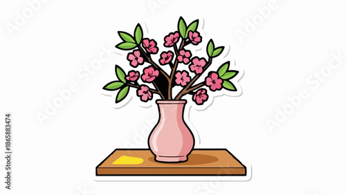 Pink blossoms in a ceramic vase sit on a wooden shelf with a yellow accent