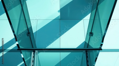 Modern glass building interior with teal shadows and light