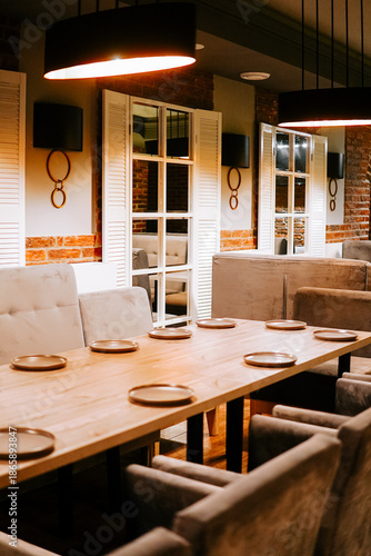 Dining area with wooden table and soft seating for guests in a restaurant setting