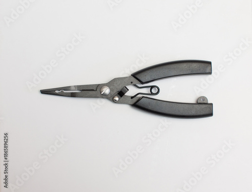 A black pair of scissors for tying hooks is placed on a white background.