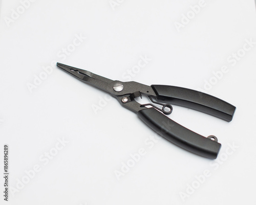 A black pair of scissors for tying hooks is placed on a white background.