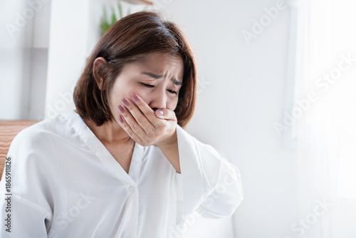 Slika na platnu Asian woman feeling nauseous and covering mouth, suffering from morning sickness