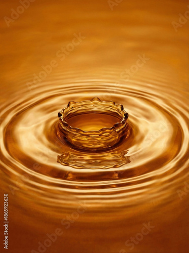 Stunning golden liquid crown splash with ripples on a honey-colored surface. Perfect for luxury or beverage concepts.
