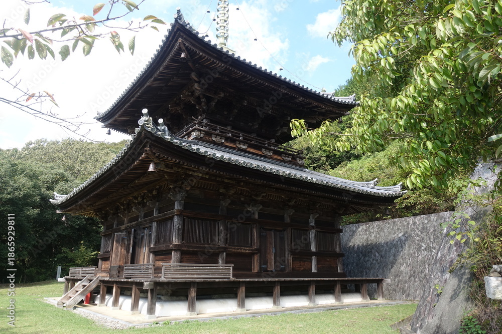 Fototapeta premium Traditional wooden Buddhist pagoda viewed from side on Shikoku Henro pilgrimage Japan