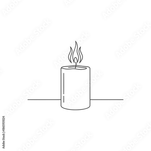 A lit candle on a table with a flame flickering in the air