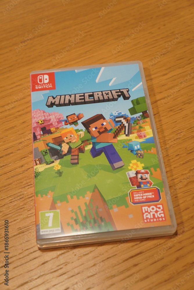 Fototapeta premium Minecraft Nintendo Switch game case featuring iconic characters and blocky landscapes