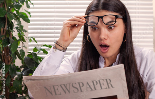 young woman with glasses and newspaper