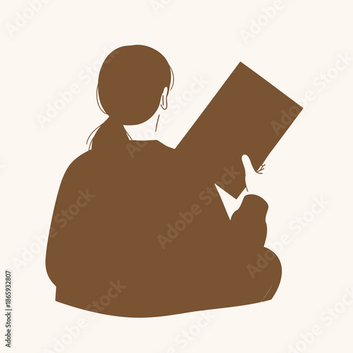 Person sitting and reading a book in a relaxed position
