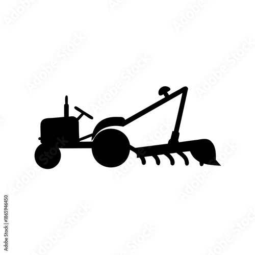 Silhouette of vintage farm tractor with plow attachment for agricultural work