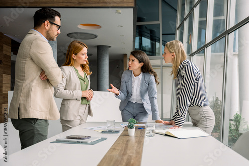Business team discussing project at table in modern office