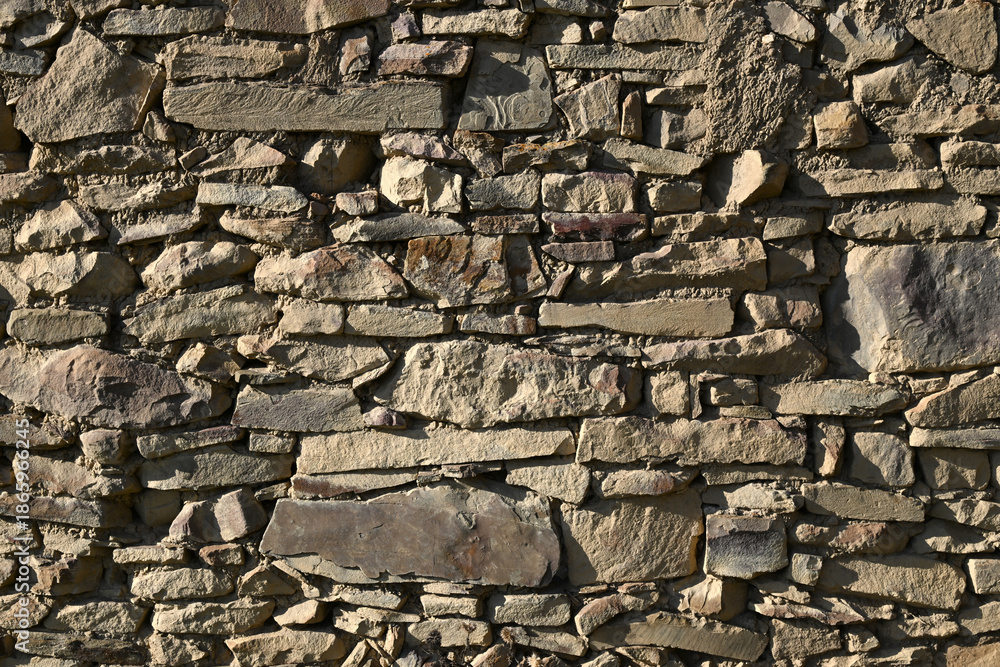Fototapeta premium Textured vintage-style wall made of decorative mountain stone