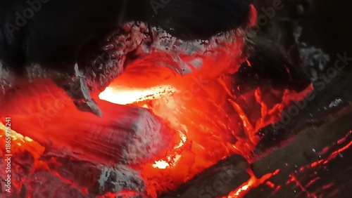 Glowing Embers: A mesmerizing close-up captures the fiery dance of glowing embers, radiating heat and light, showcasing the raw power and beauty of fire.