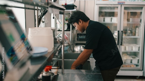 Chef working in a commercial kitchen, preparing food and maintaining cleanliness
