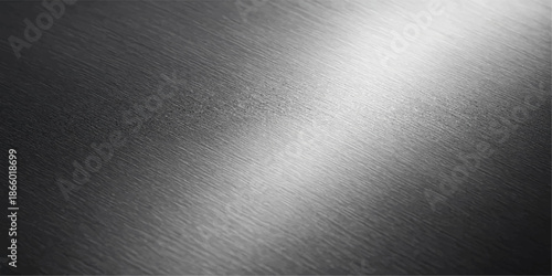 Shiny brushed metal texture background with a polished silver stainless steel surface featuring a dark gray metallic aluminum plate pattern and light reflections on a sleek industrial material backdro