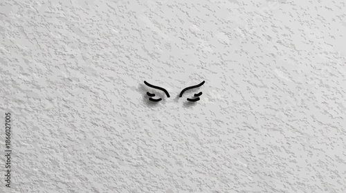 Minimalist Black Stylized Closed Eyes on White Textured Surface, Evoking Grumpiness, Thought, or Rest