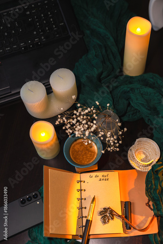 Cozy workspace with to-do list, coffee and candles – planning and mindfulness concept