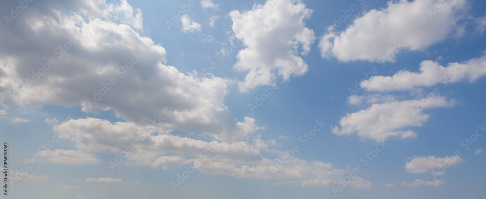 Obraz premium Panoramic blue sky with white floating clouds