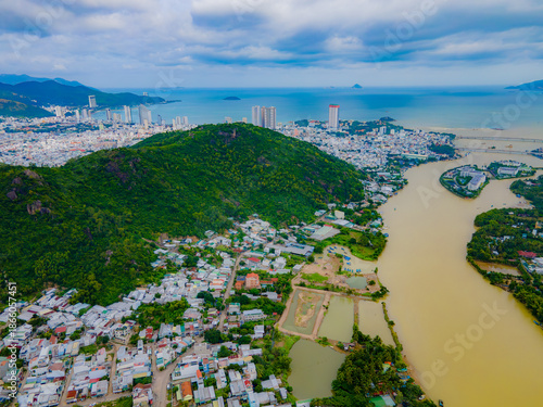 A muddy river during the rainy season. The Kai River in Nha Trang, Vietnam. During the rainy season, the river is replenished with water from the mountains and turns dirty due to the muddy bottom. 