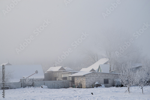 Fog covered the houses in the village in the morning