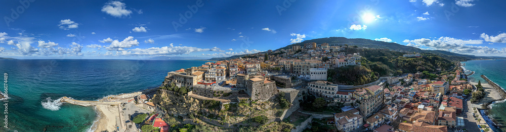 Fototapeta premium Aerial view of Pizzo Calabro, pier, castle, Calabria, tourism Italy. Panoramic view of the small town of Pizzo Calabro by the sea. Houses on the rock. On the cliff stands the Murat Aragonese castle