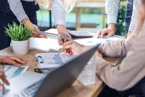 Executive business team people group working with documents at table, analyzing corporate strategy, reviewing plan, managing financial project overview at office meeting, digital tablet, laptop. © ty