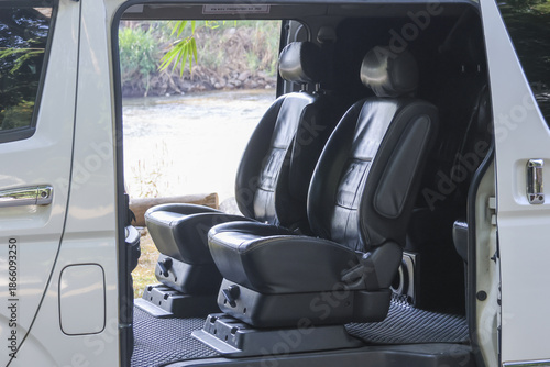 Quadro su tela Luxury interior of white passenger van featuring comfortable black leather seat