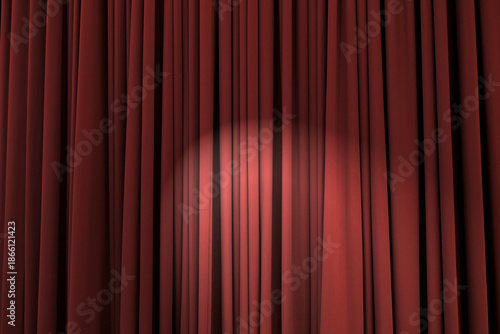 Background texture of deep red, heavily corrugated curtain with stage light in the middle