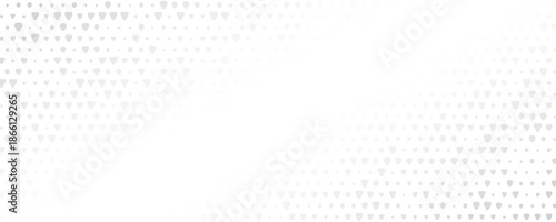 An abstract pattern of grey dots gradually fading into white. The design features a gradient effect, transitioning from dense clusters to sparse dots.